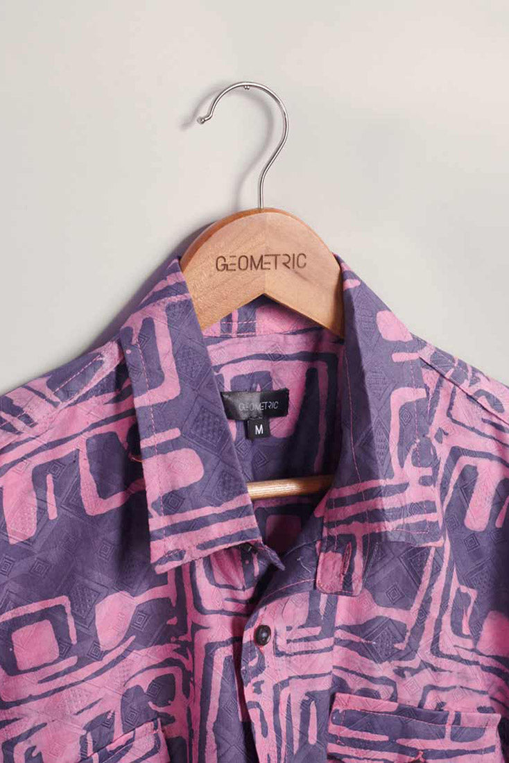 Close-up of hand-dyed purple Coco batik print short sleeve button up shirt by GEOMETRIC. 