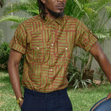 Man wearing hand-dyed green batik Garden Gate print short sleeve button up shirt by GEOMETRIC. 