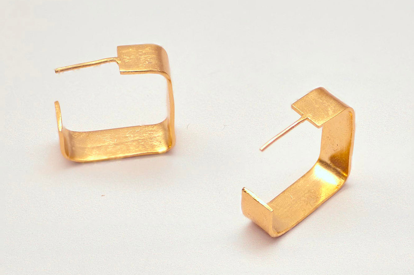 Brass square hoop earrings by GEOMETRIC. 