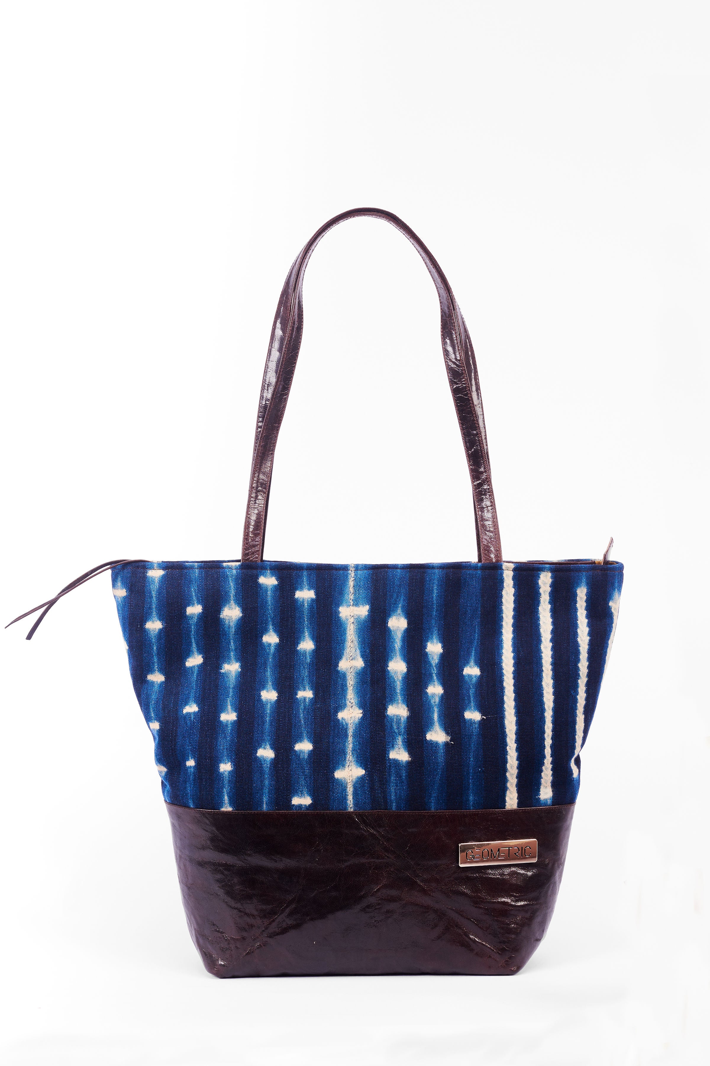 Hand-dyed indigo fabric and leather Tema tote bag by GEOMETRIC. 