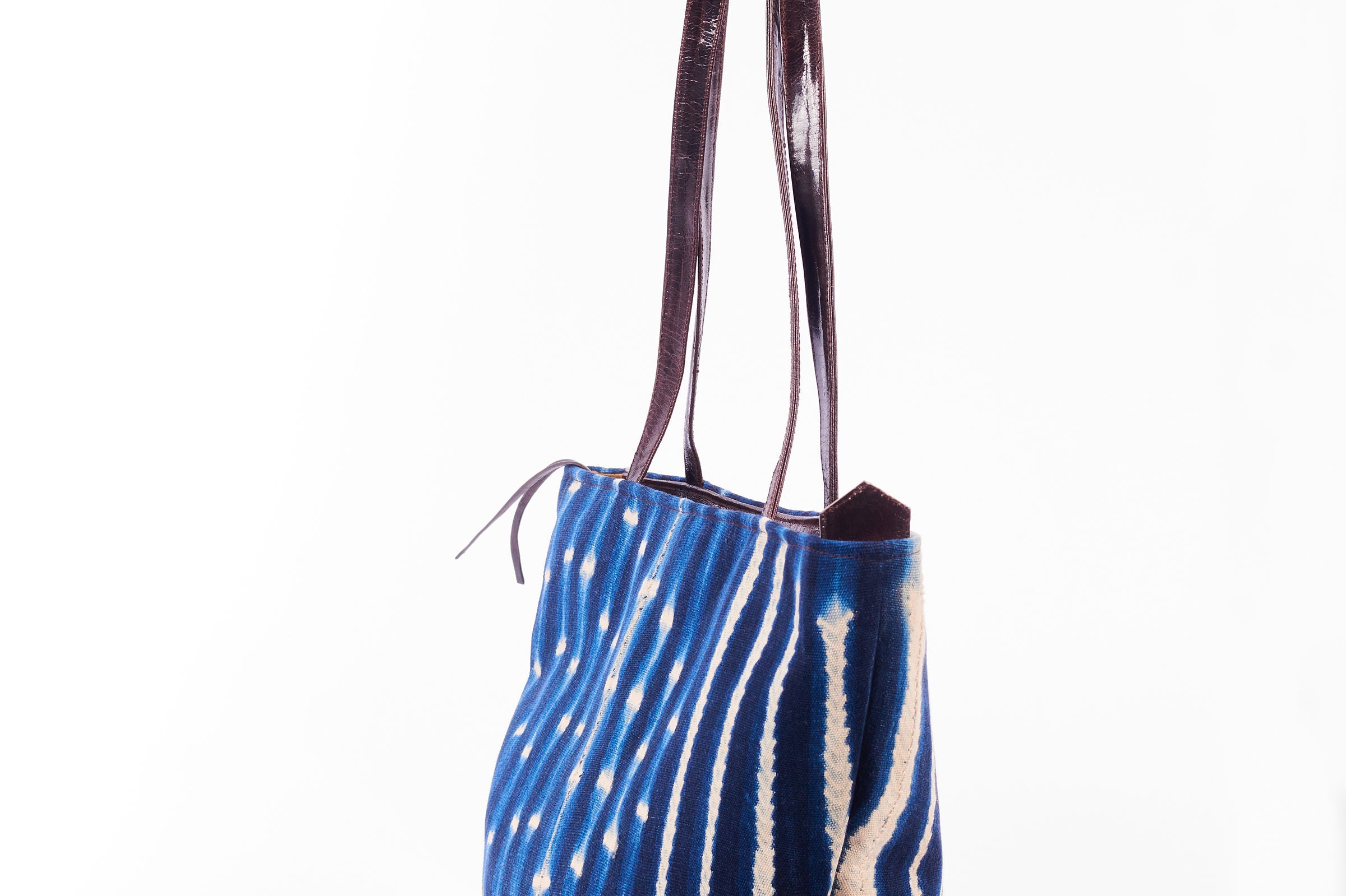 Hand-dyed indigo fabric and leather Tema tote bag by GEOMETRIC. 