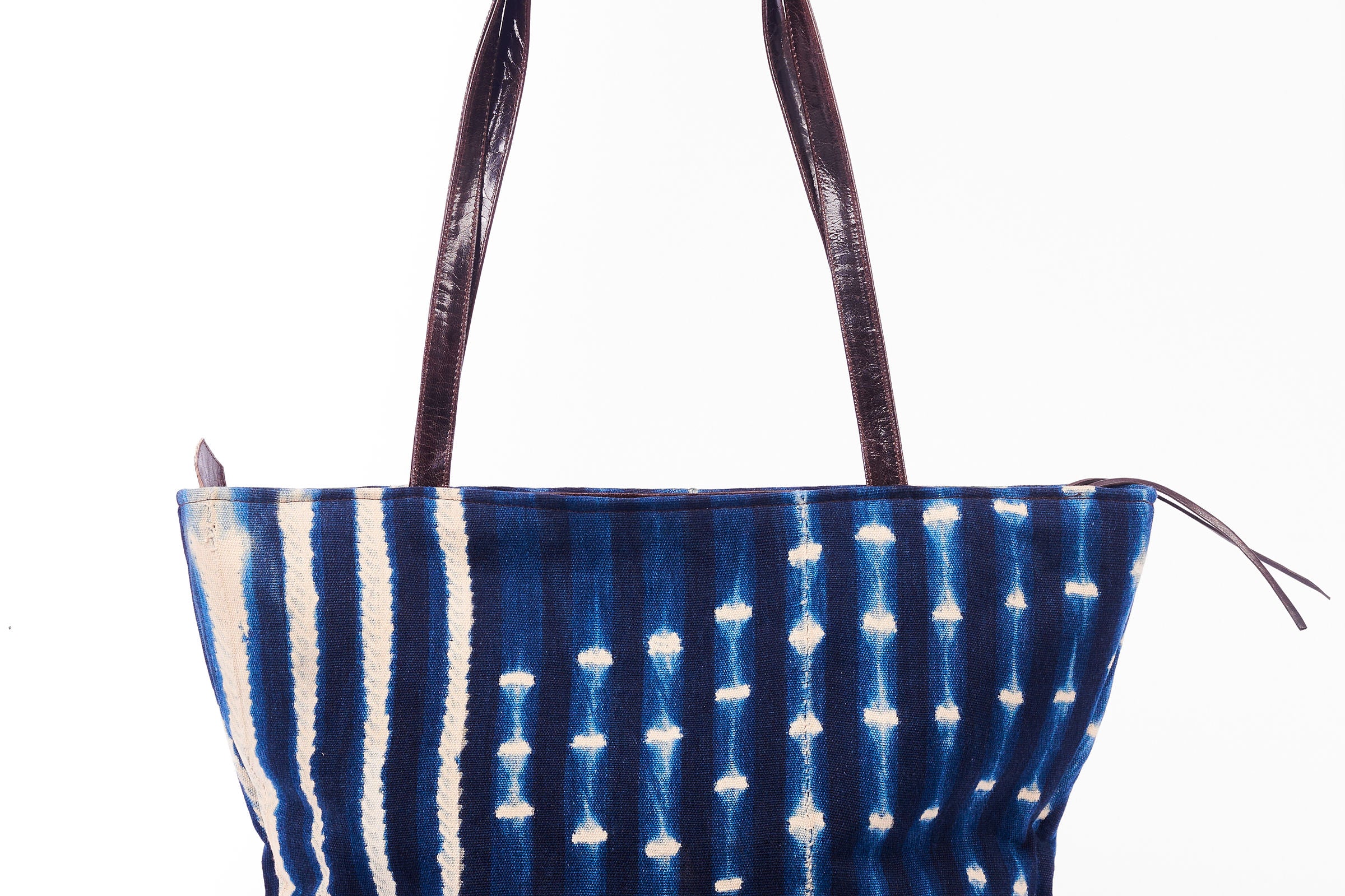 Hand-dyed indigo fabric and leather Tema tote bag by GEOMETRIC. 