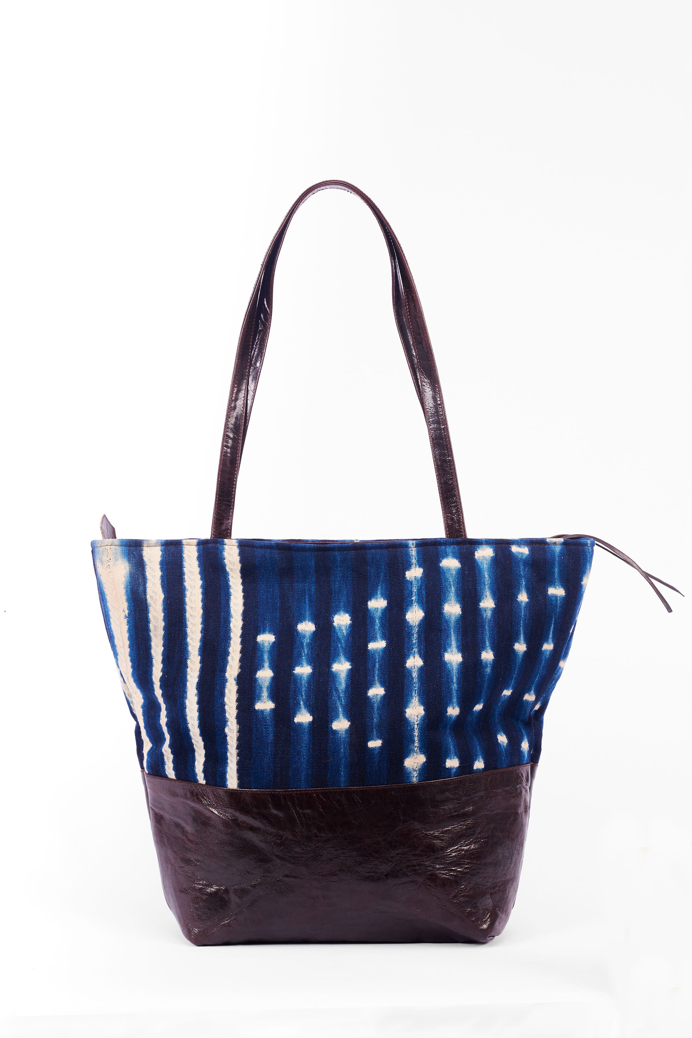 Hand-dyed indigo fabric and leather Tema tote bag by GEOMETRIC. 
