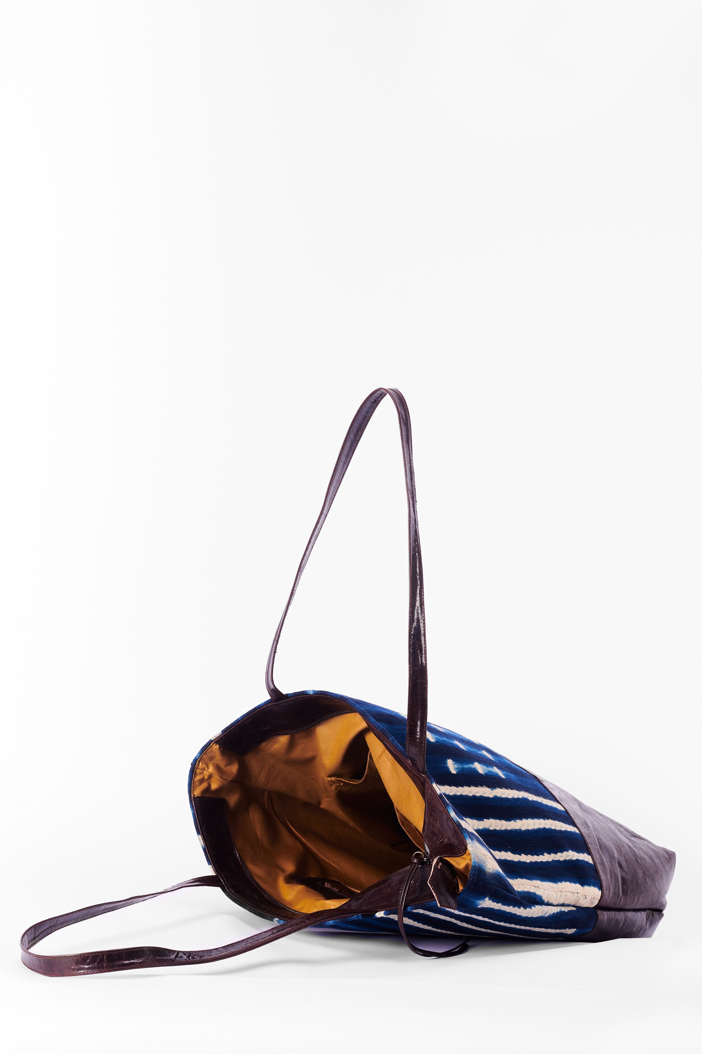 Inside view of hand-dyed indigo fabric and leather Tema tote bag by GEOMETRIC. 