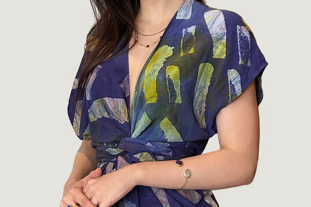 Woman wearing hand-dyed navy Kaleidoscope wrap dress by GEOMETRIC. 