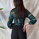 Back view of woman wearing navy hand-dyed batik Brush Strokes print long sleeve wrap top by GEOMETRIC. 