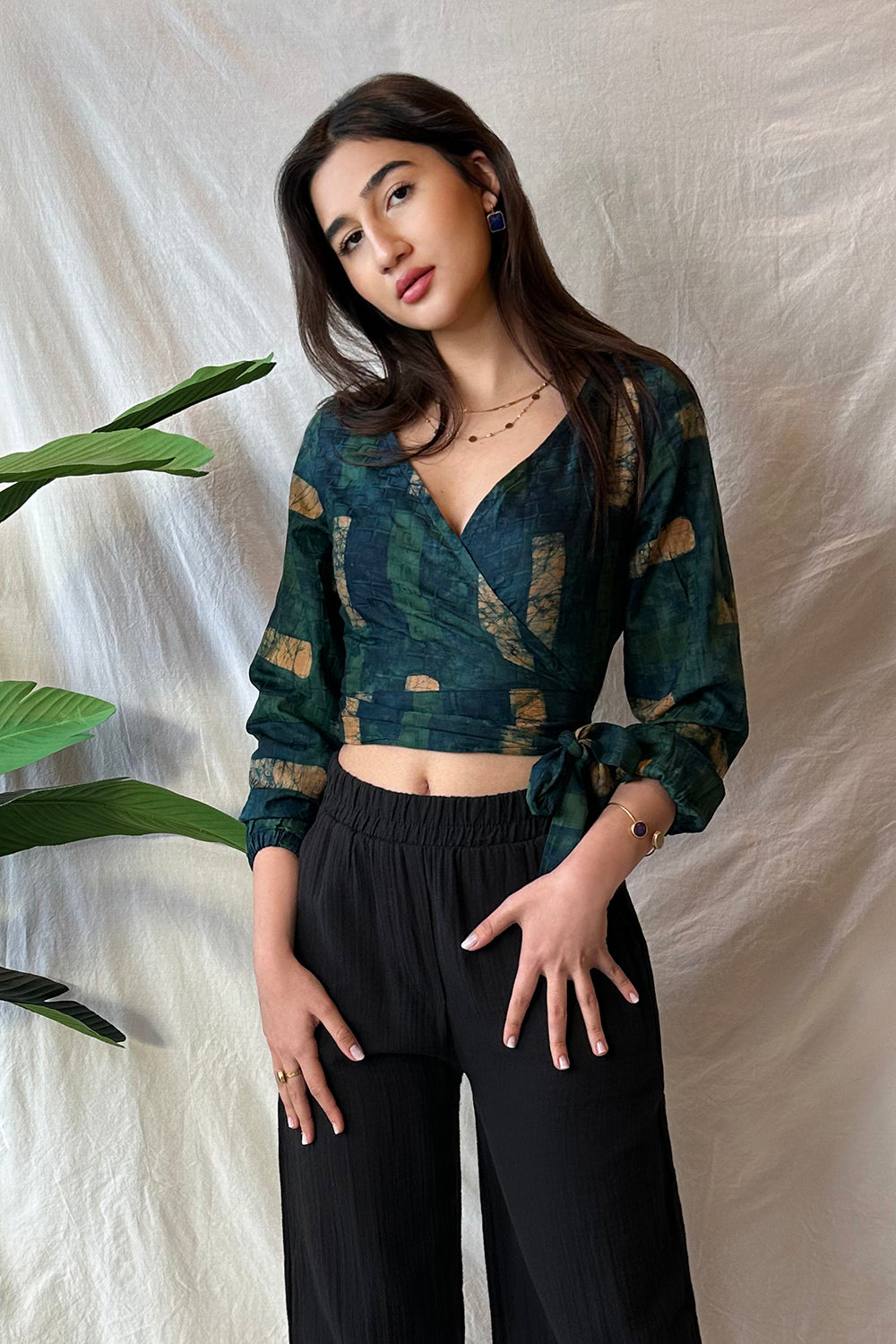 Woman wearing navy hand-dyed batik Brush Strokes print long sleeve wrap top by GEOMETRIC. 