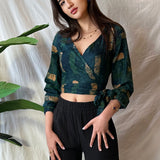 Woman wearing navy hand-dyed batik Brush Strokes print long sleeve wrap top by GEOMETRIC. 