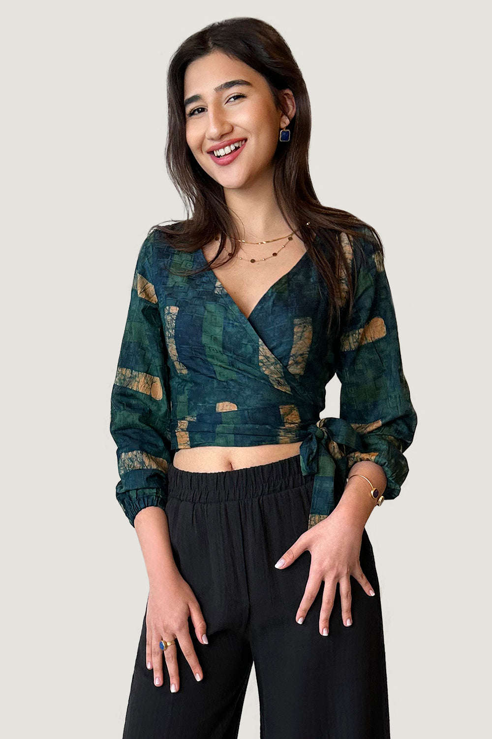 Woman wearing navy hand-dyed batik Brush Strokes print long sleeve wrap top by GEOMETRIC. 
